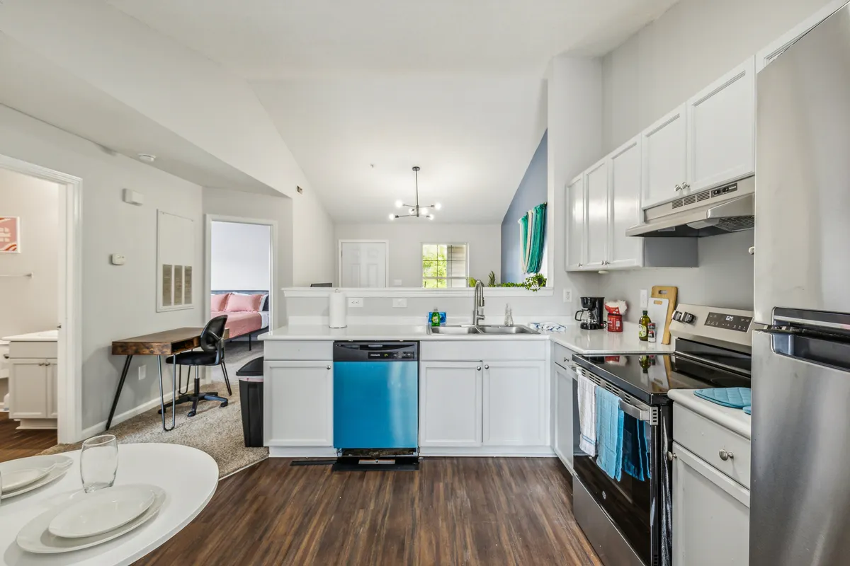 A stylish kitchen featuring a central island, stainless steel appliances, and vibrant window treatments. The island offers extra prep space or a spot for quick bites, while the appliances suggest ease and efficiency for any home chef.